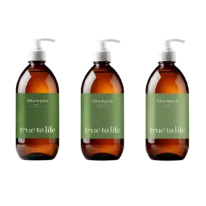 Three brown shampoo bottles with white pump tops lined up in a row against a black background; green labels read 'Shampoo' with varying porosity texts.