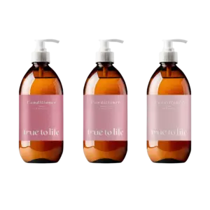 Three identical brown pump bottles with pink conditioner labels lined up on a black background, showing different porosity text: high, medium, and low.